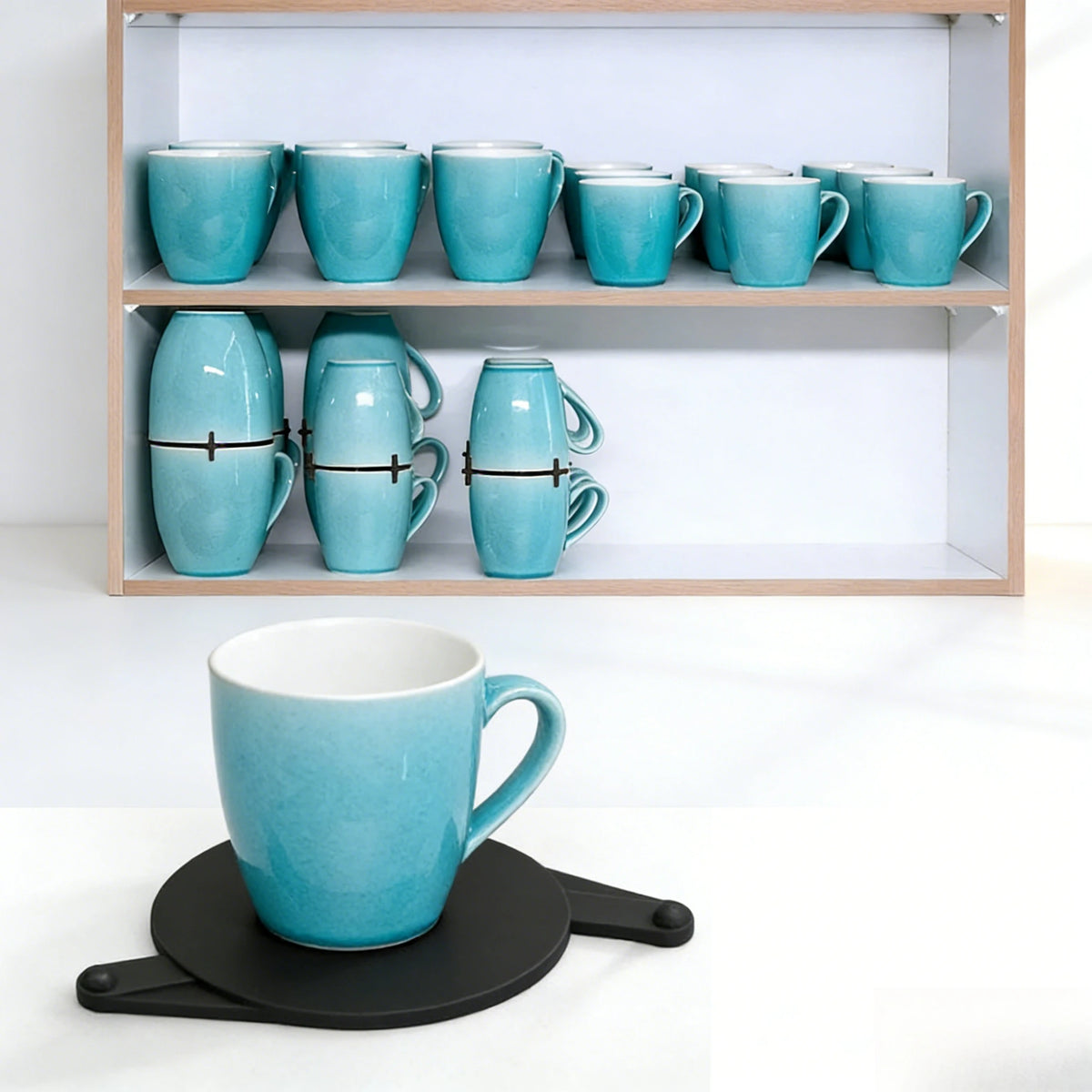 Set of turquoise mugs on a shelf with a single mug in front