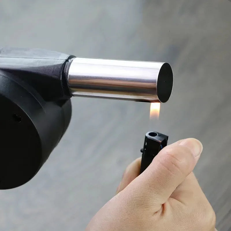 Hand holding a lighter igniting a black cylindrical device against a gray background