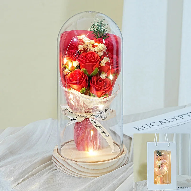 Soap rose flower arranged under clear acrylic cover
