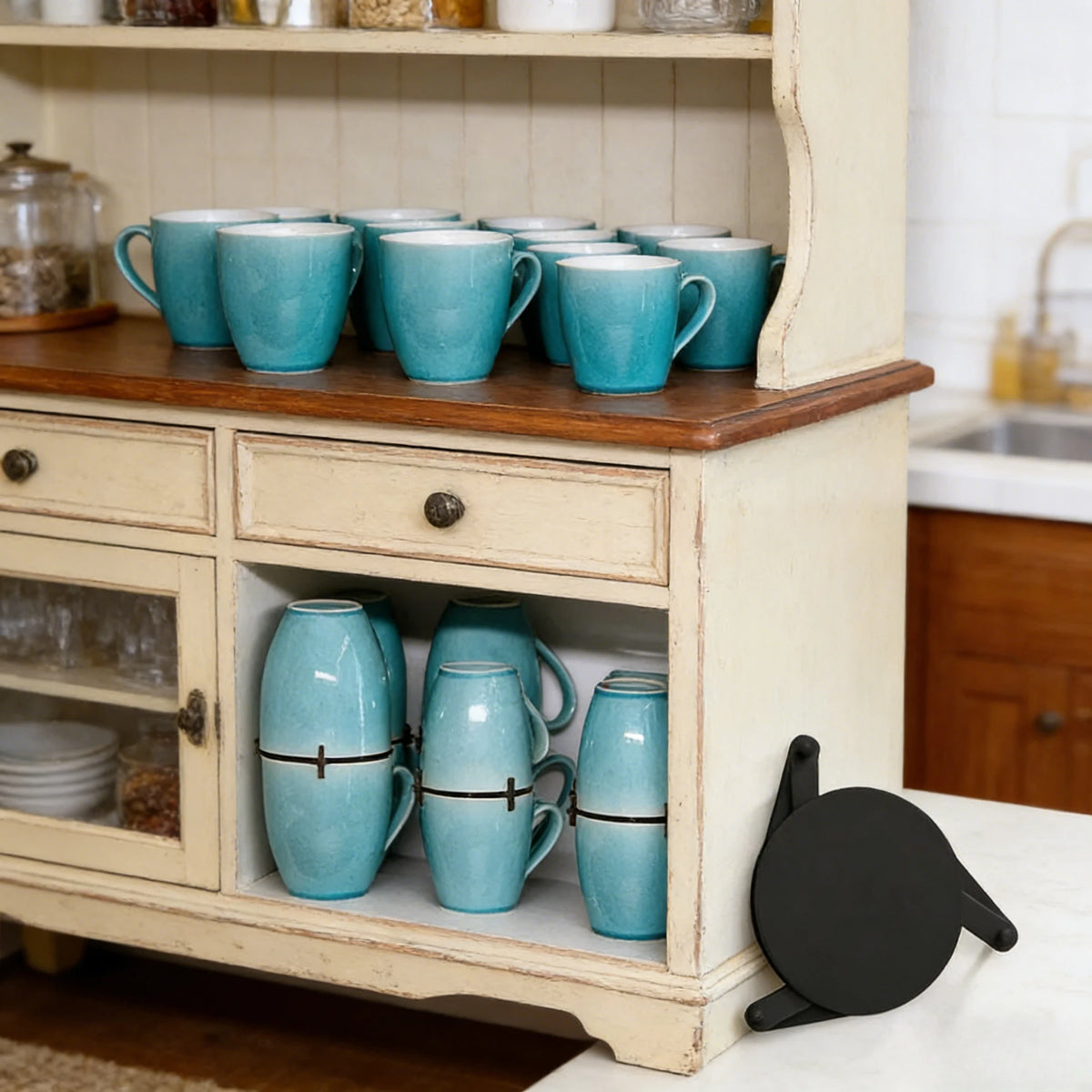 Teal mugs on a wooden shelf and cabinet in a kitchen setting