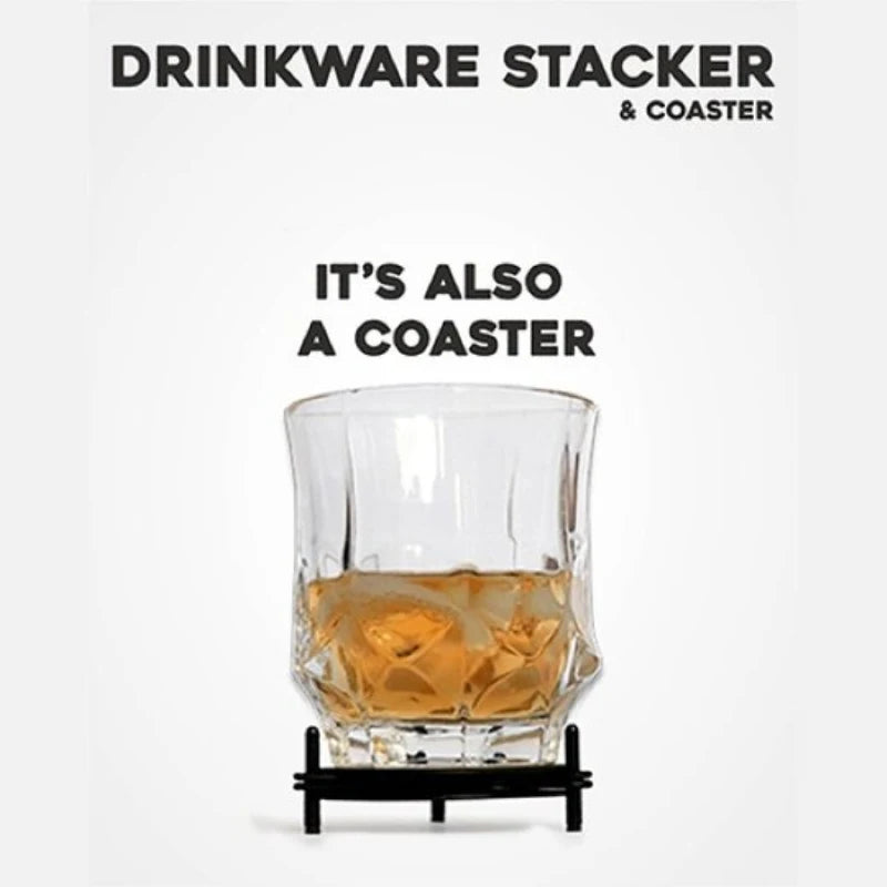 A clear cut-glass tumbler coaster with a black metal stand, shown holding an amber drink and ice cubes. The product is presented on a clean white background with black text reading 'DRINKWARE STACKER & COASTER' and 'IT'S ALSO A COASTER'.